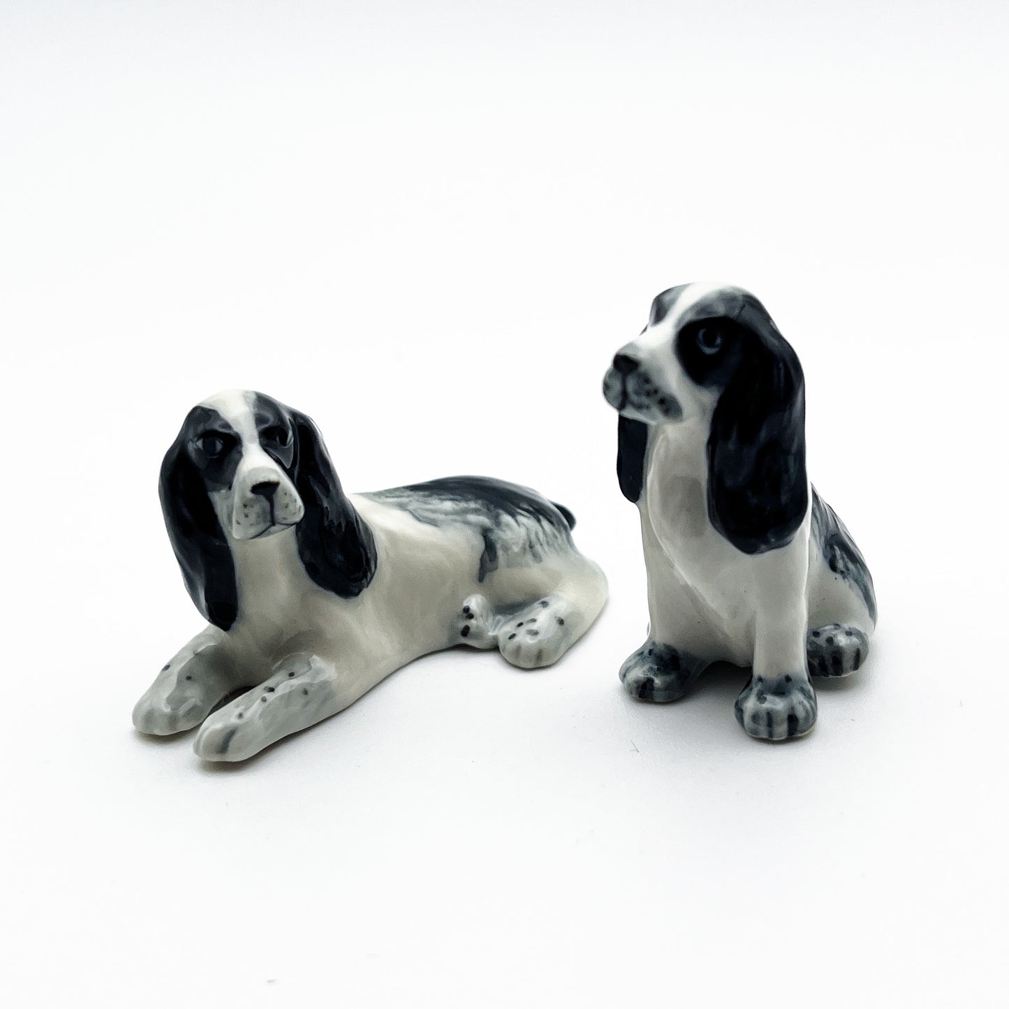 2 White and Black Cocker Spaniel Dogs