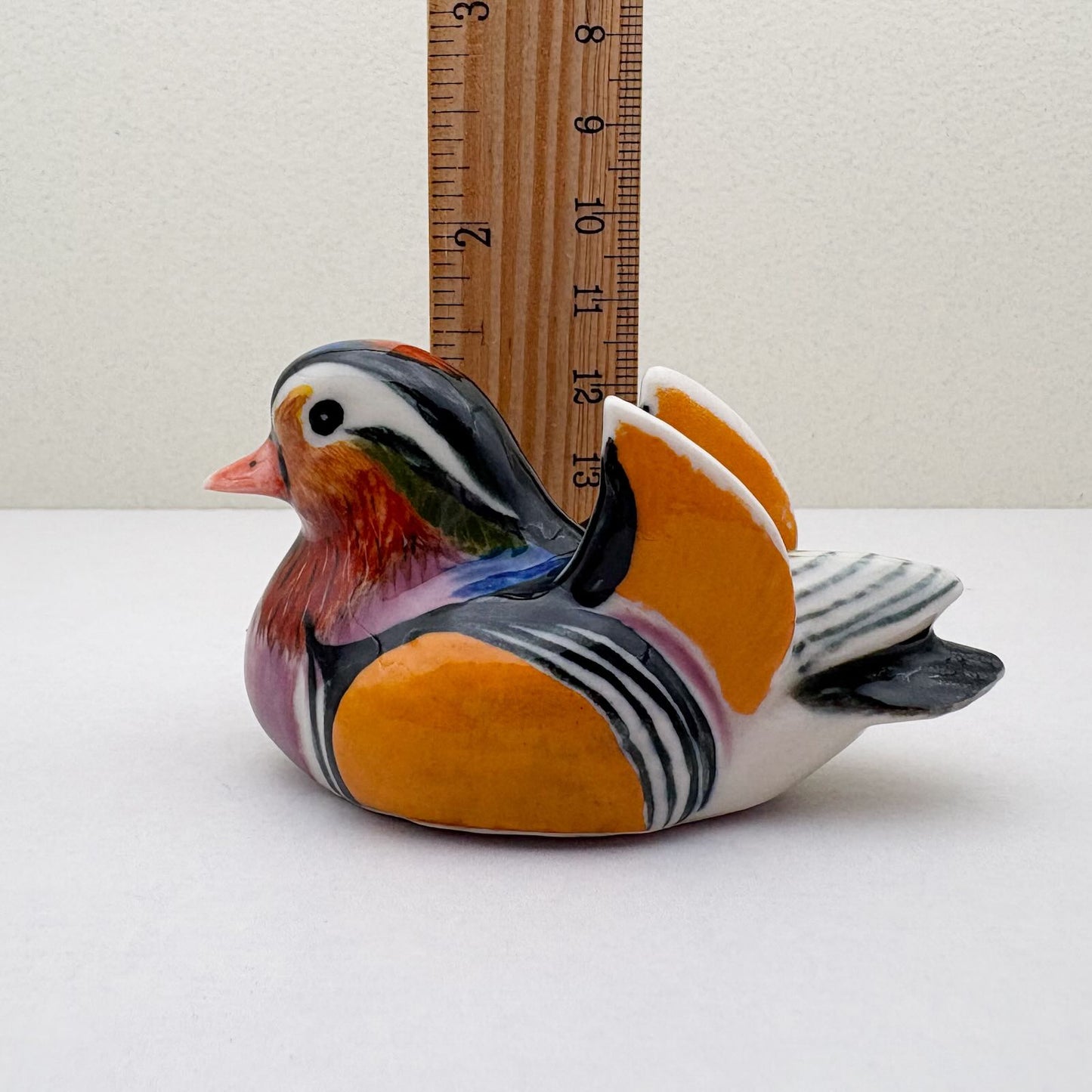 Ceramic Duck Figurine next to a ruler