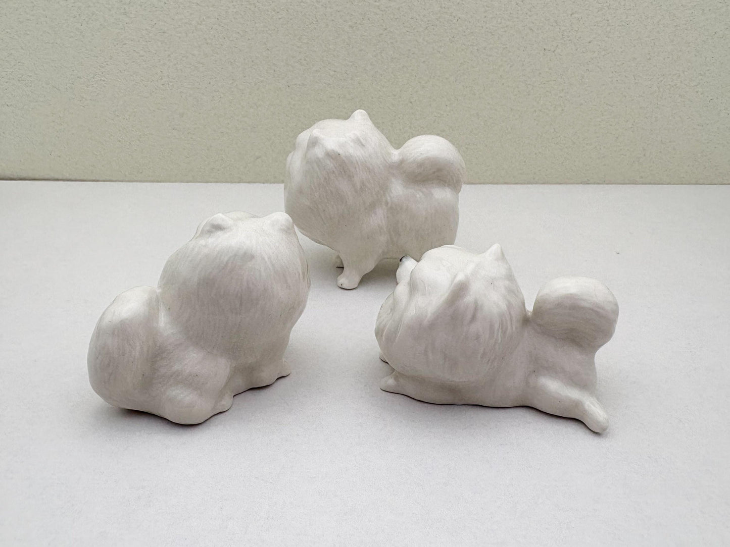 Charming White Ceramic Pomeranian Figurine Set, Trio of Lifelike Dog Figurines in Unique Poses, Ideal for Pet Lovers, Home Decor Enthusiasts